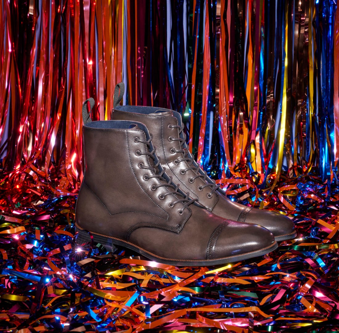 Shop the classics featuring a gray boot with a colorful tinsel backdrop.