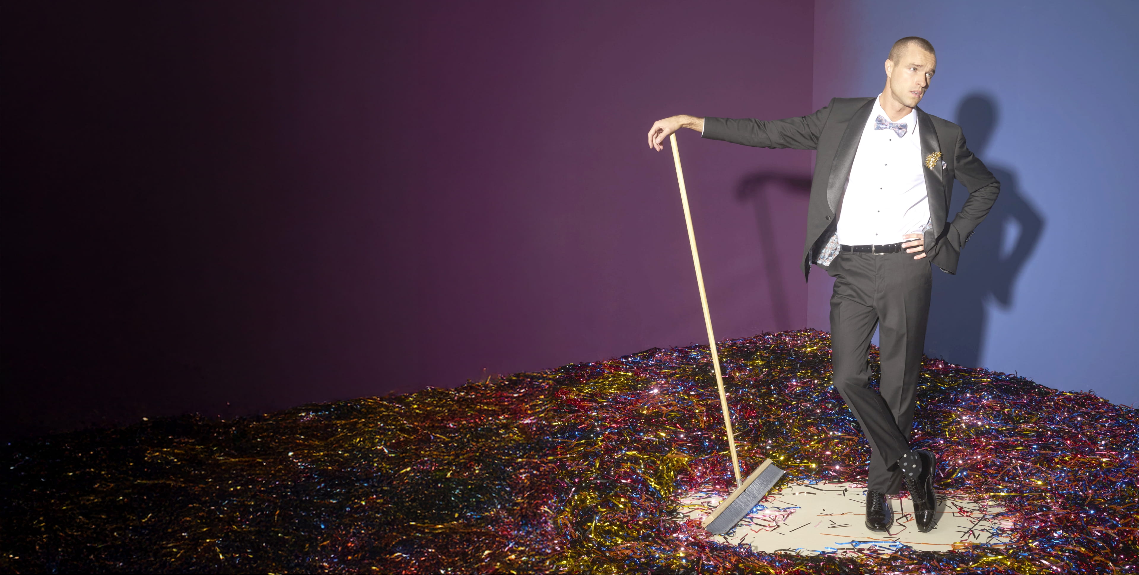Shop our end of season clearance featuring a man sweeping up tinsel.