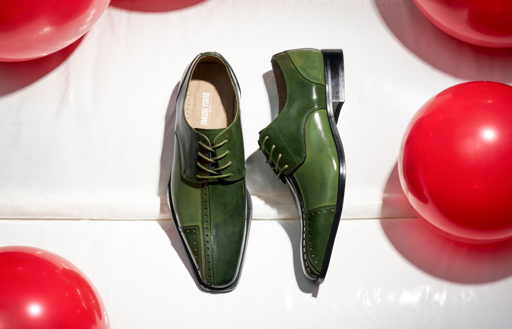 Shop this seasons hottest color: green. Featuring a green oxford on a white background with red balls.