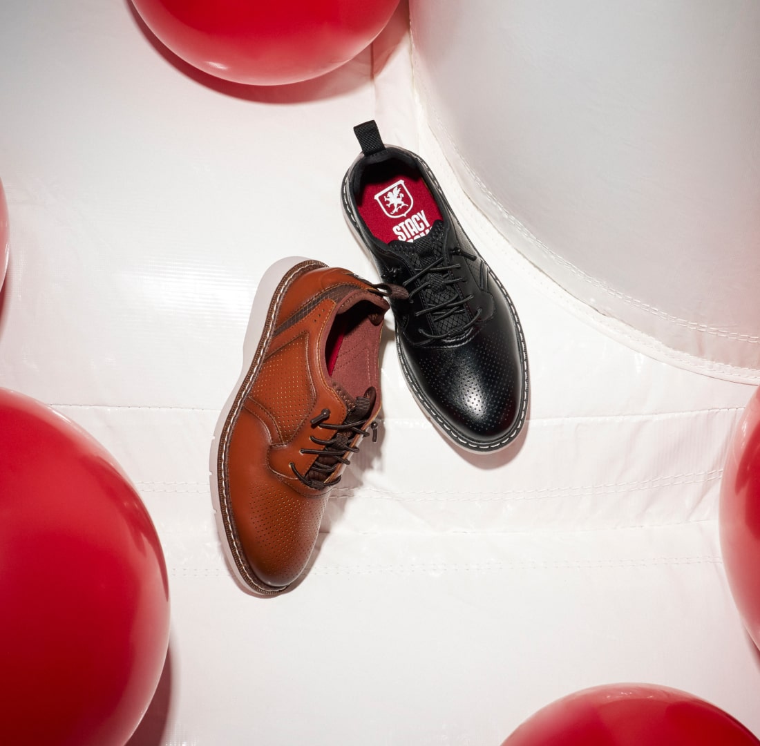 Shop styles for the whole family, featuring 2 kids shoes on a white background.