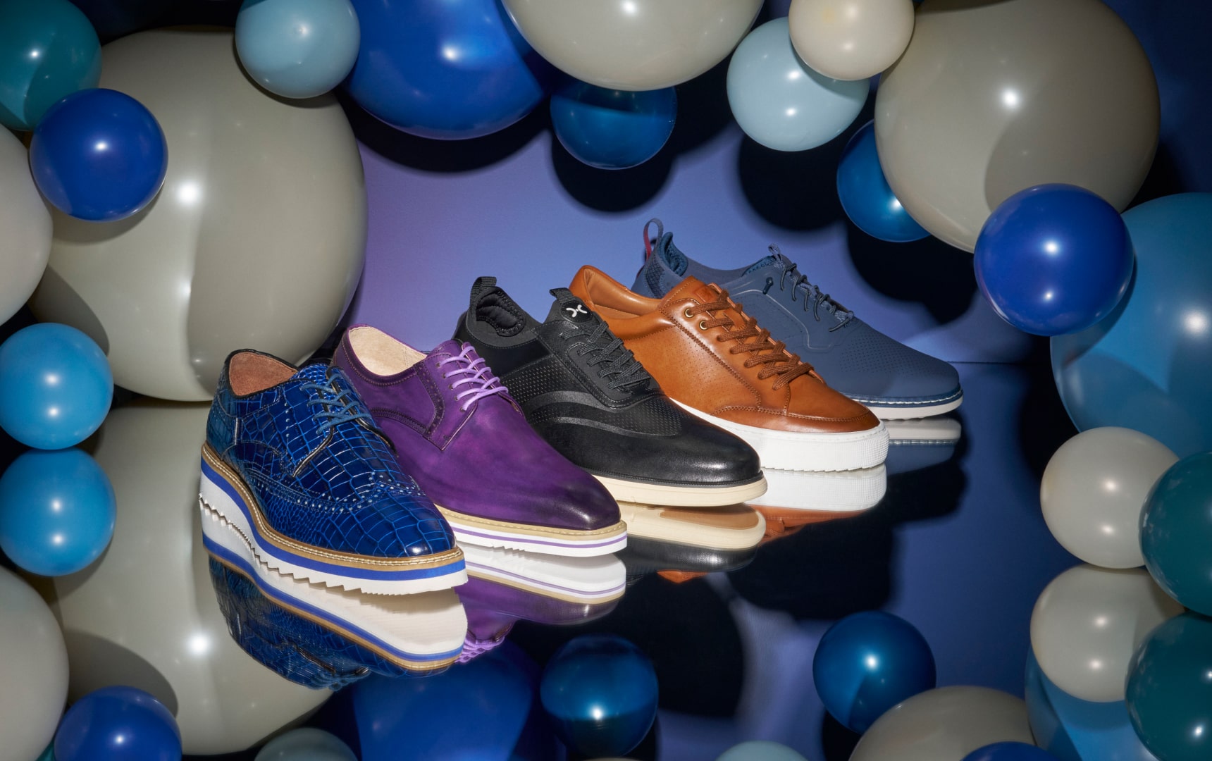 Shop Stacy Adams hybrids featuring a variety of styles in front of a balloon arch.