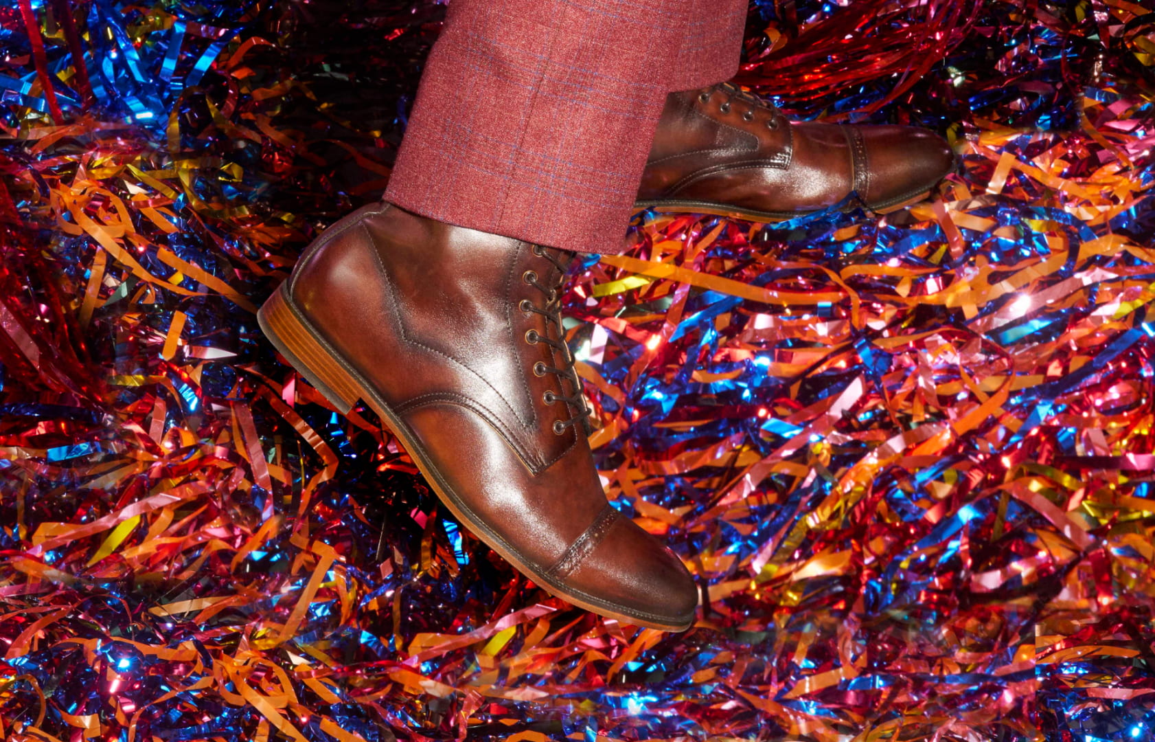 Shop Stacy Adams dress shoes featuring the Henry boot on a colorful tinsel floor.