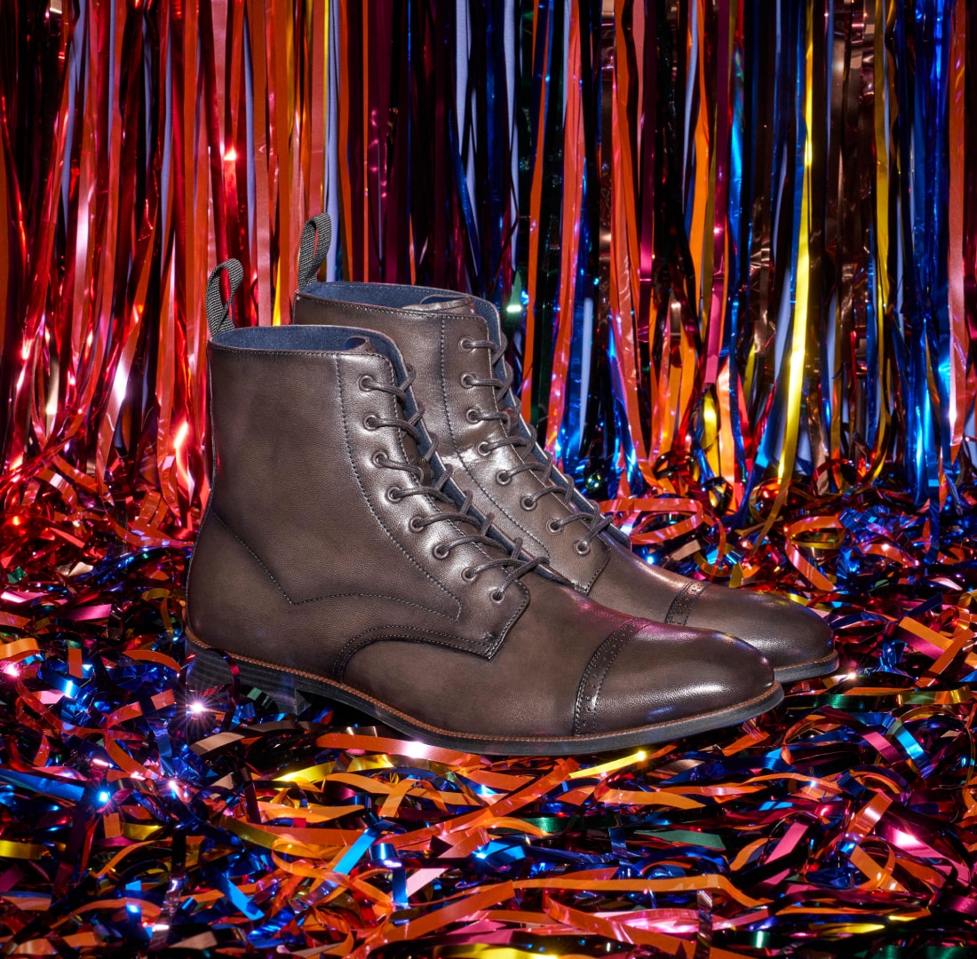 Shop Stacy Adams classics featuring the Henry boot in gray on a bed of tinsel.