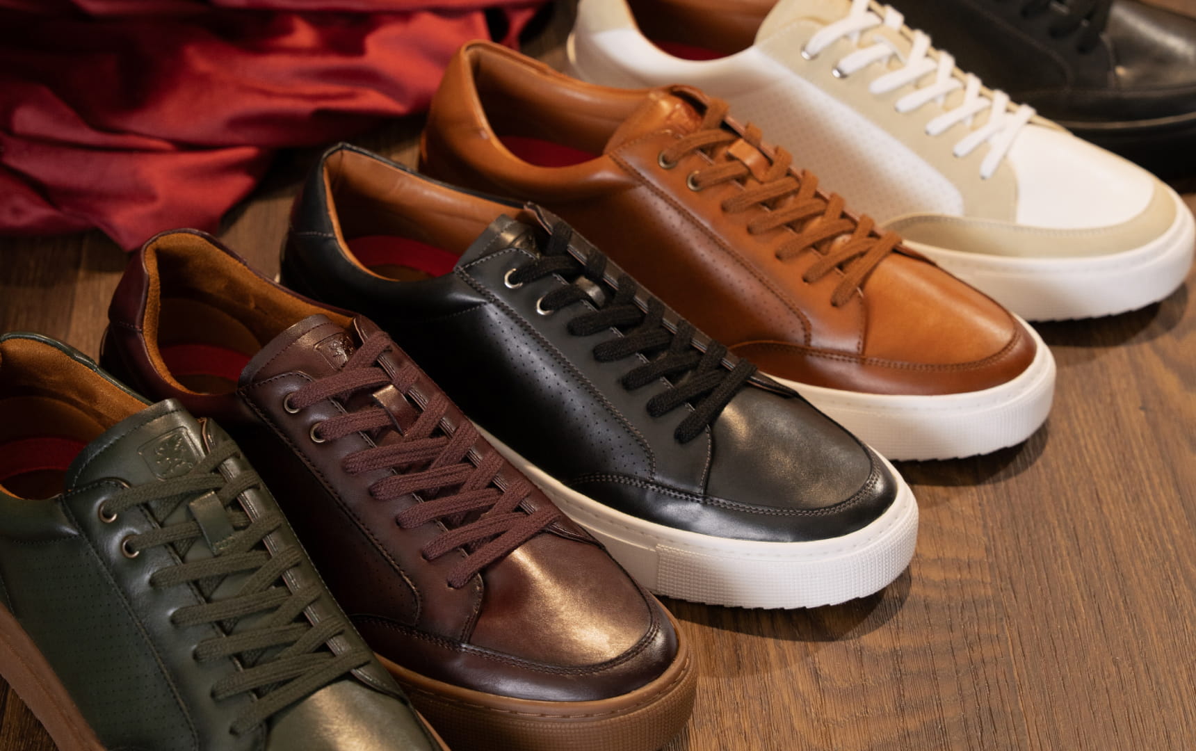 Shop the Stacy Adams Dorian Lace to Toe Sneaker featuring a variety of colors on a wood floor background.