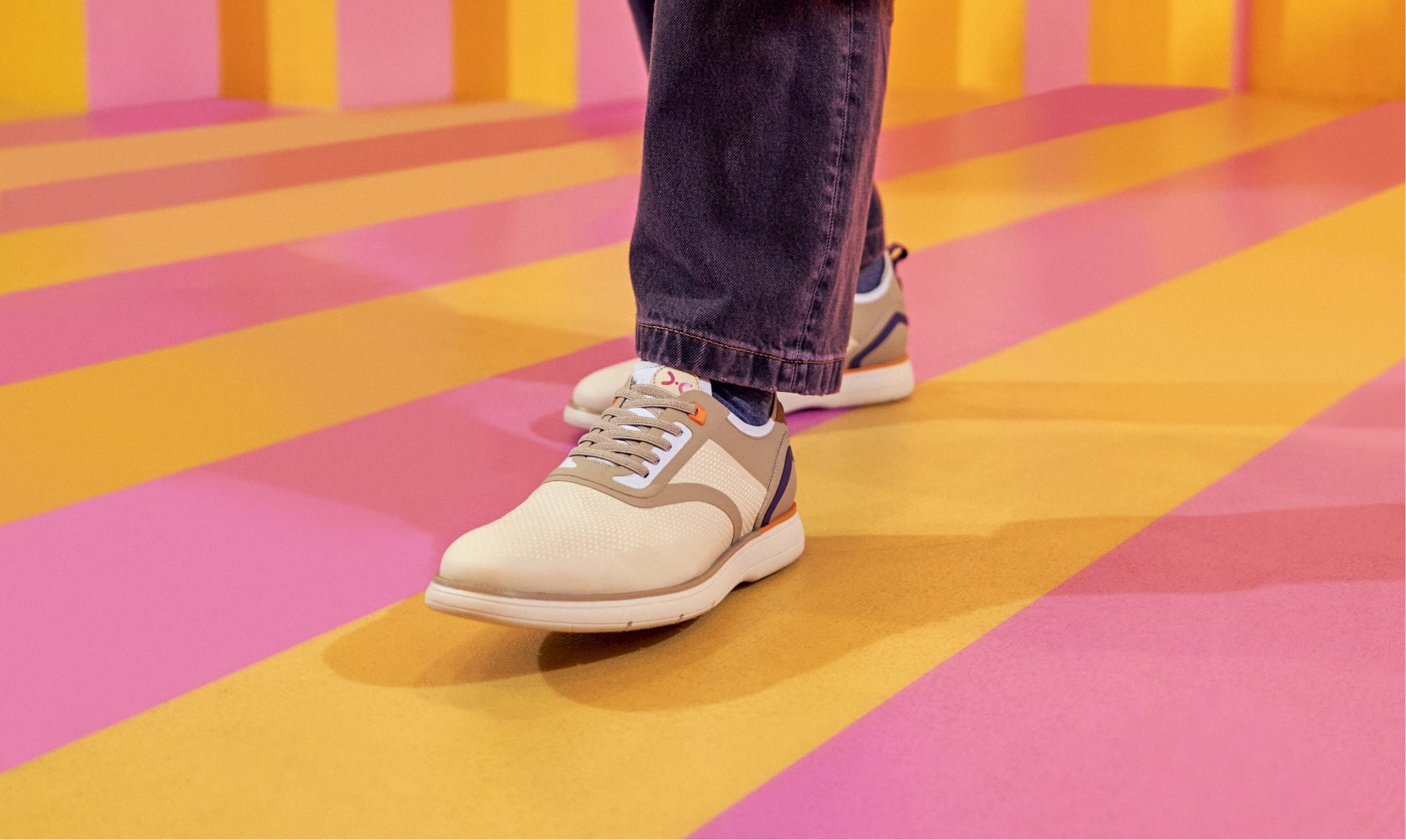 Click to shop Stacy Adams casuals featuring the Everidge in cream on a pink and yellow striped floor.