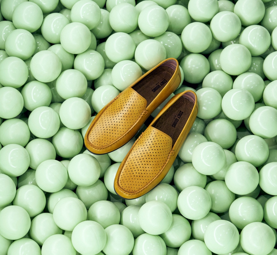 Image features the Conroy loafer in tan on a background of mint green.