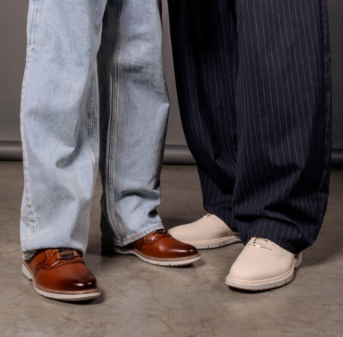 Shop our Father's Day picks featuring a knee down shot of a man and his son in Stacy Adams sneakers.