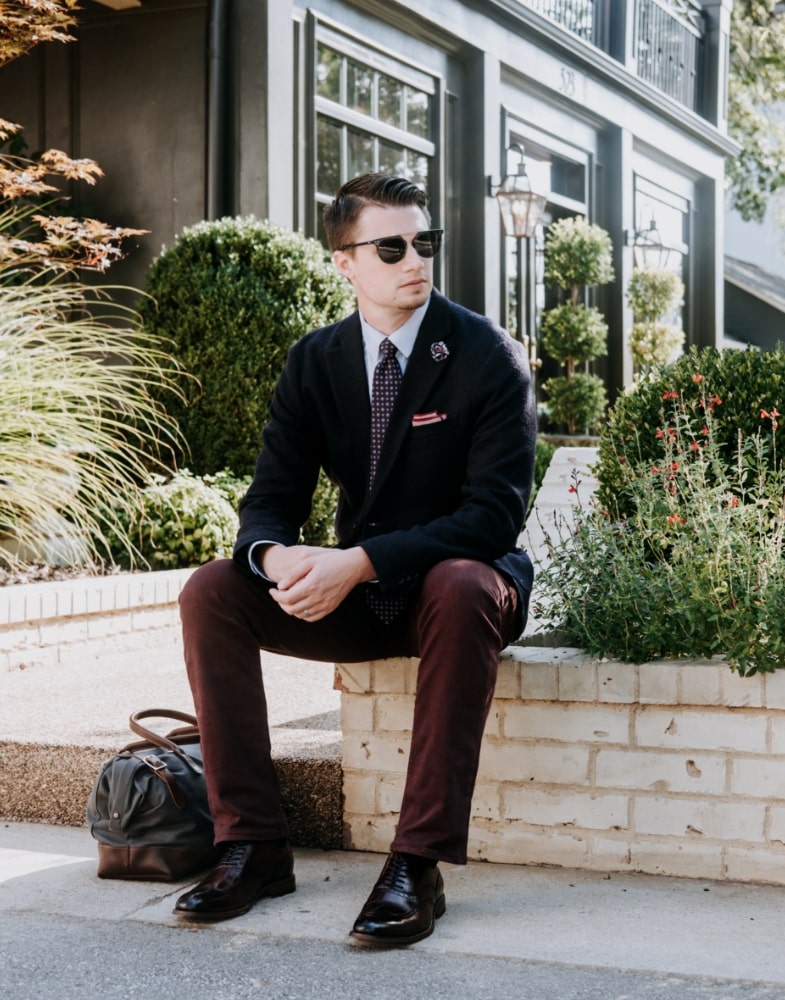 Image of social media influencer Matt Hartman wearing the Dunbar Wingtip Oxford in Burgundy while relaxing outside.