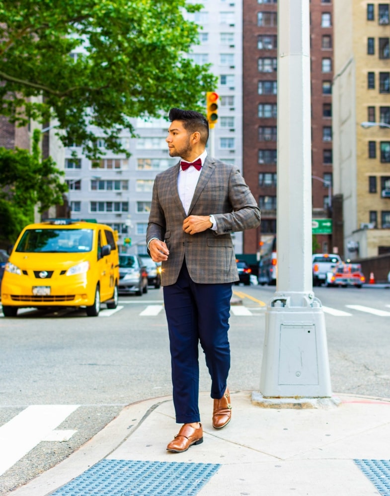 Image of social media influencer Diego Leon wearing the Madison Cap Toe Double Monk Strap in Oak while crossing the street.