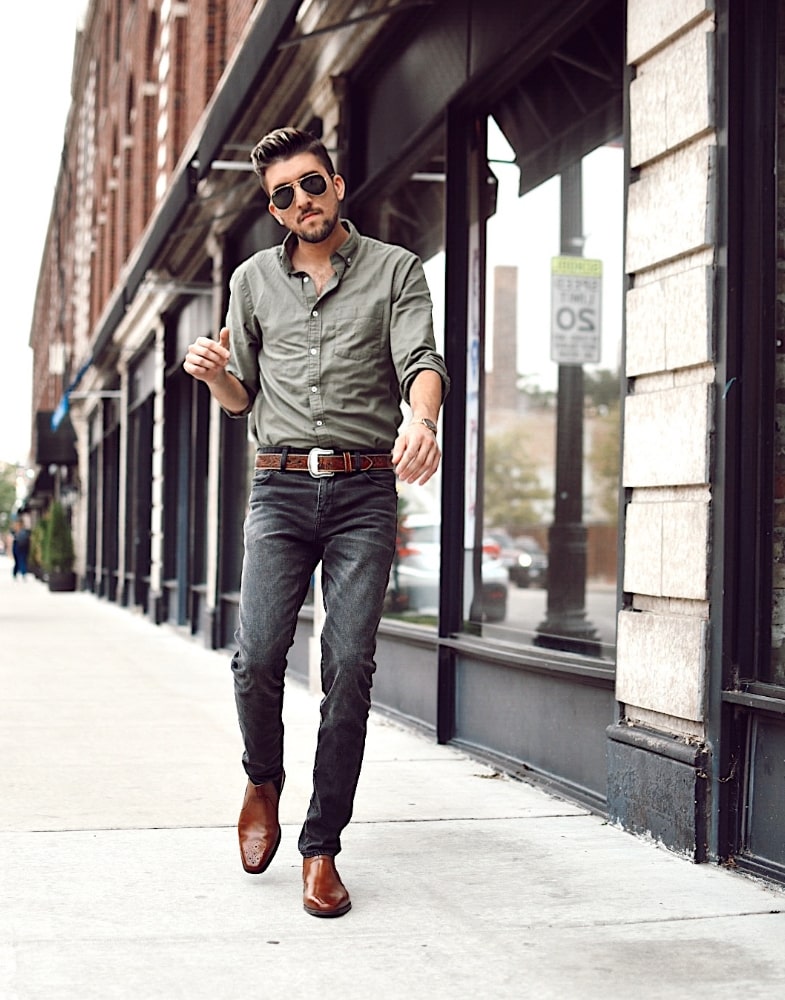 Image of social media influencer Thomas Trust walking on a sidewalk wearing the Perrin Plain Toe Chelsea Mid Boot in Cognac.