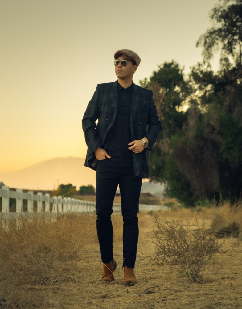 Image of social media influencer Vince Lee walking outside in the Roane Plain Toe Chelsea Buckle Boot in Tan Suede.