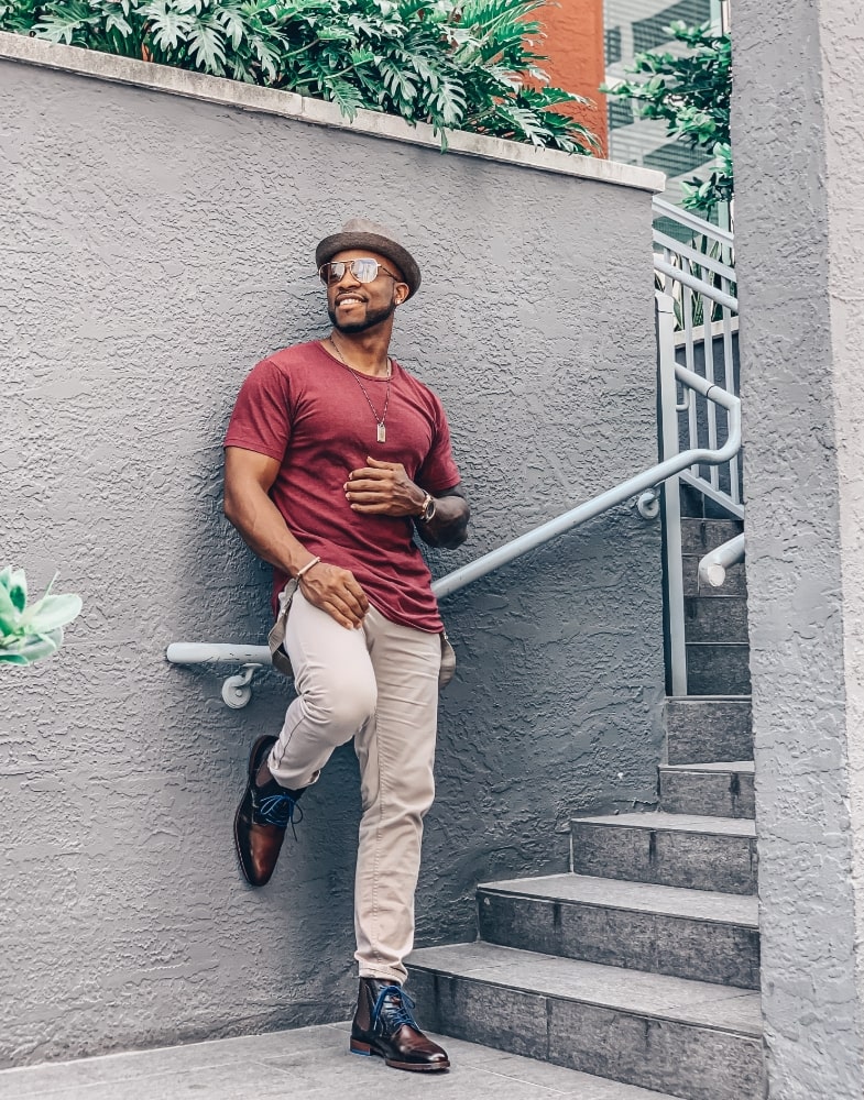Image of social media influencer Kenny Daniels wearing the Rupert Plain Toe Lace and Gore Boot in Brown while leaning against a building.