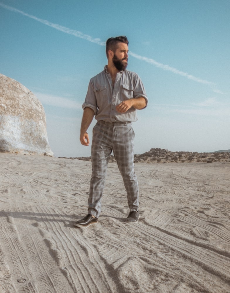 Image of social media influencer Ben Juster walking on sand in the Sideline Plain Toe Slip On in Black.