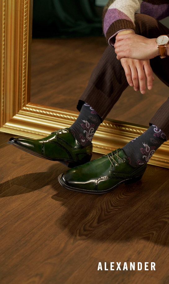 Men's Fashion Shoes category. Image features the Alexander Plain Toe Oxford in green on hardwood floors.