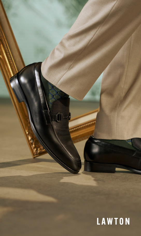 Men's Dress Shoes category Image features the Lawton Moc Toe Bit Slip On in Black with a picture frame behind the shoes.