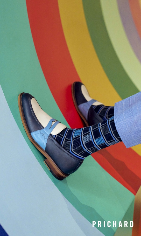  Image features the Prichard in navy multi on a rainbow background.