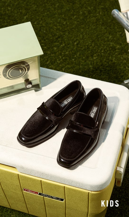 Kids Shoes view all category. Image features the Kids Spratley in black. 