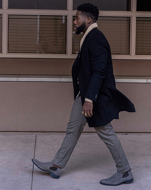 Image of social media influencer East Angles walking down the street in the Roane Plain Toe Chelsea Buckle Boot in Gray Suede.