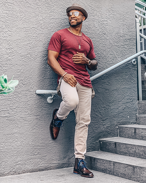 Image of social media influencer Kenny Daniels wearing the Rupert Plain Toe Lace and Gore Boot in Brown while leaning against a building.