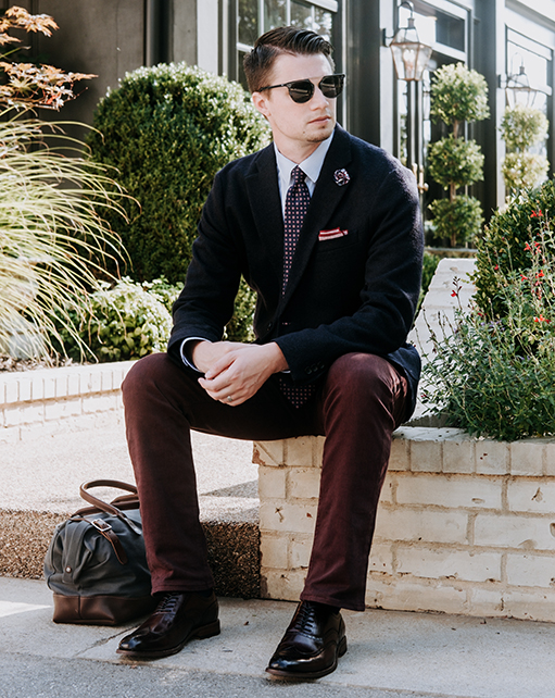 Image of social media influencer Matt Hartman wearing the Dunbar Wingtip Oxford in Burgundy while relaxing outside.