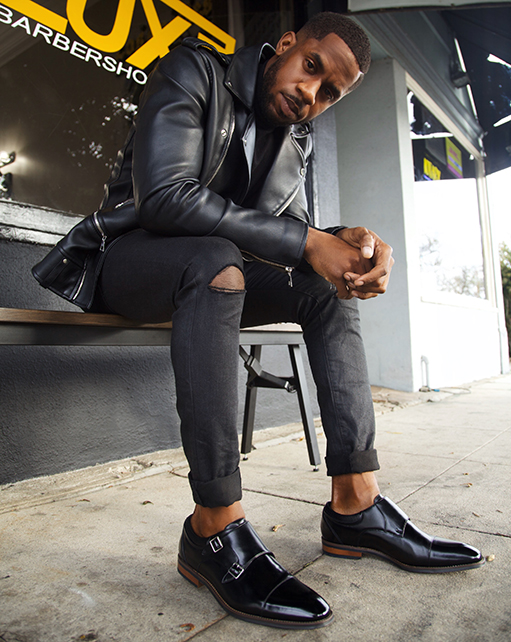 Image of social media influencer Chidi Ezemma wearing the Bayne Cap Toe Double Monk while sitting on a bench outside.